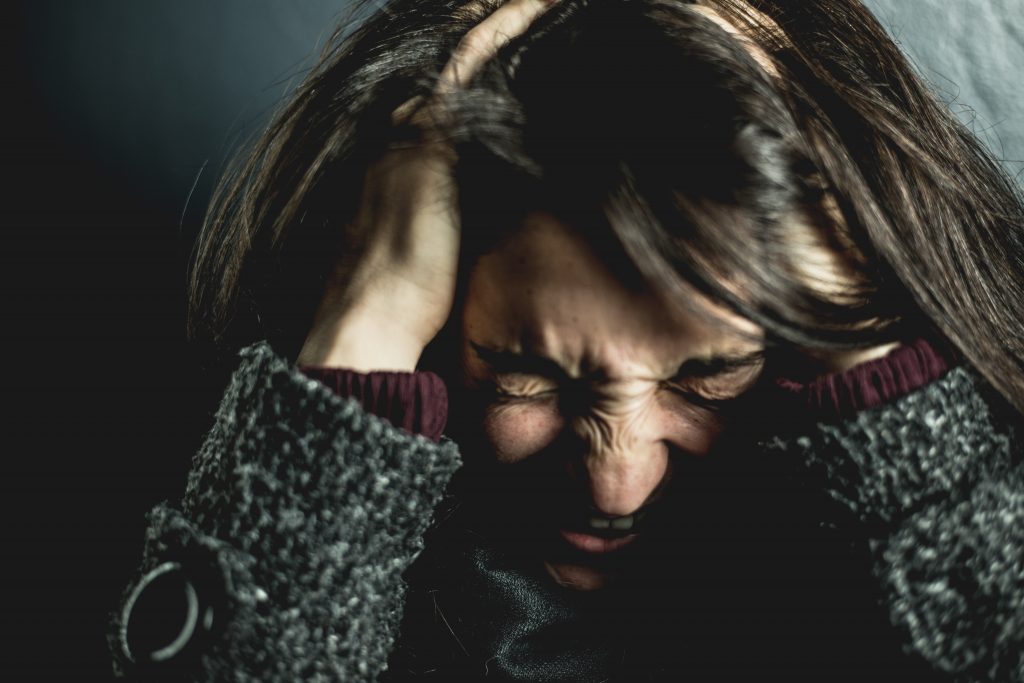 woman holding her head 2128817 scaled
